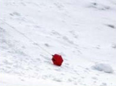 Red ball lying on the avalanche surface